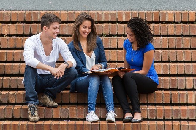 A group of people sitting on steps.