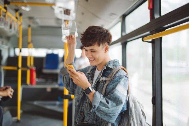A male standing in the bus.